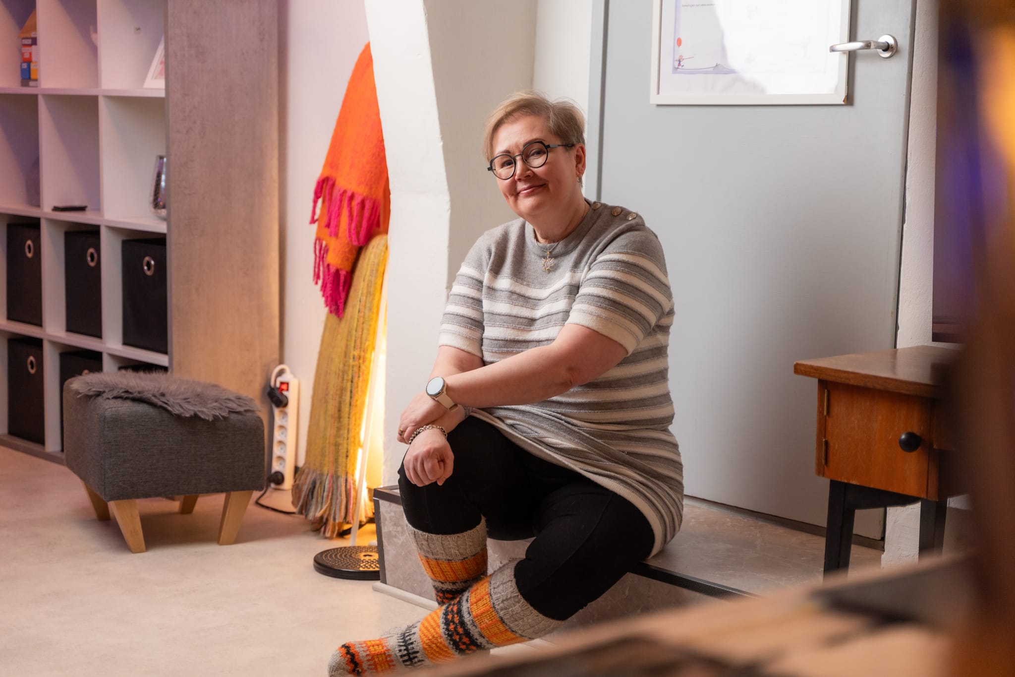 Ratkaisukeskeinen lyhytterapeutti Minna Ruohtula istumassa lattialla terapiatilassa